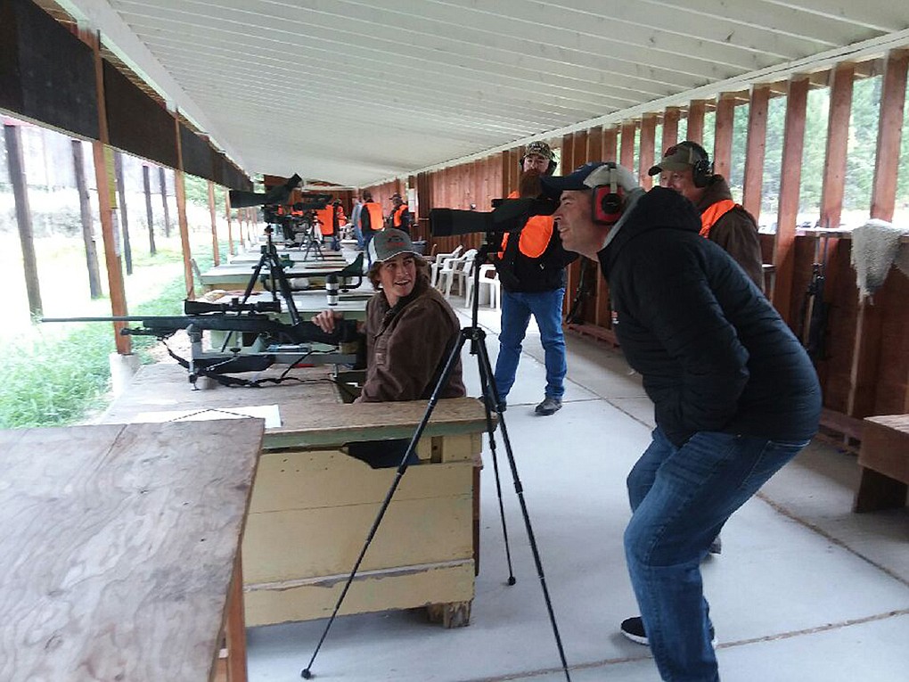 DIRK BURKE peers through a sighting scope after his son Trevor fired a shot from his rifle Oct. 5 at the Whitefish Rifle and Pistol Club hunter annual sight-in. Club members, from right, Dave Landstrom and Justin Beauregard were part of the team that assisted hunters as they prepared for the upcoming big game season. The club will host another sight-in Oct. 19-20. (Scott Shindledecker/Daily Inter Lake)