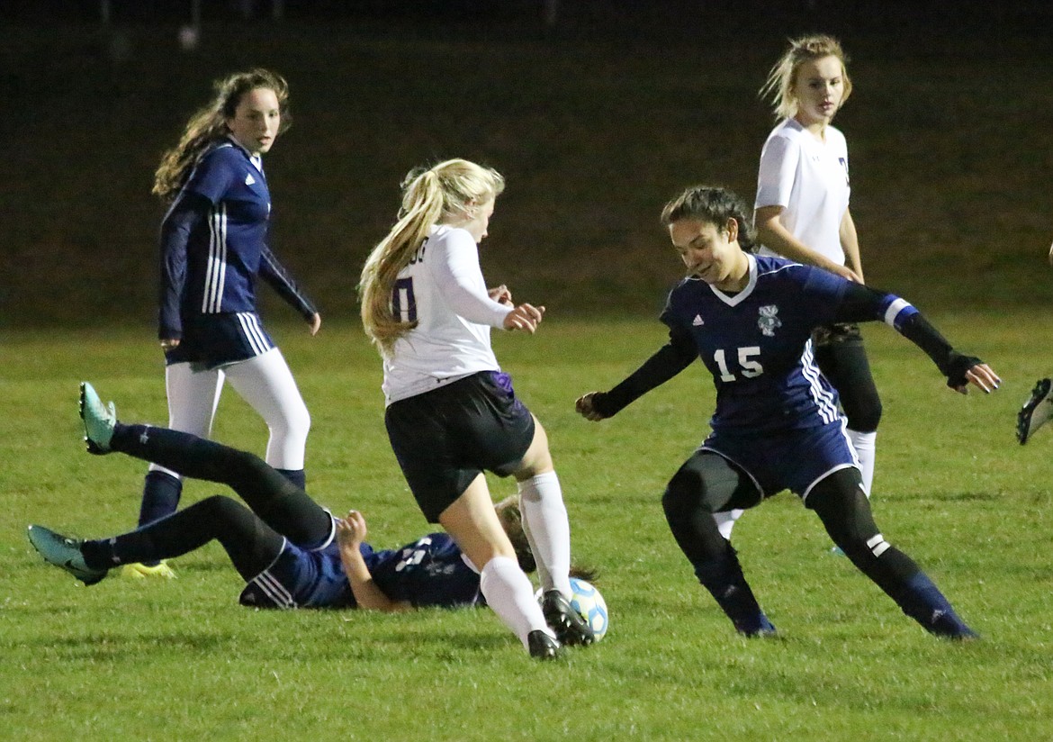 Left photo: Senior Jennifer Schmitz guards a Kellogg player during the Badgers&#146; 1-0 victory over the visiting Wildcats on Tuesday, Oct. 1. Eika Willis scored the game-winning goal for Bonners Ferry.

Right photo: Junior Morgan Swanson sends the ball upfield against Kellogg
Photos by MANDI BATEMAN