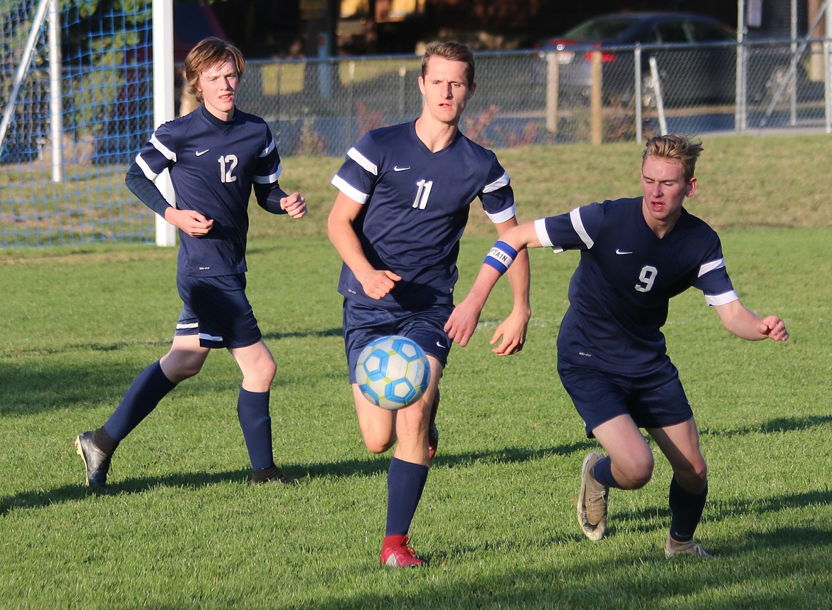 Photo by MANDI BATEMAN
Ben Tadlock, Preston Mcleish and Ben Tompkins chase down a ball during the Badgers&#146; Oct. 1 match with Immaculate Conception.