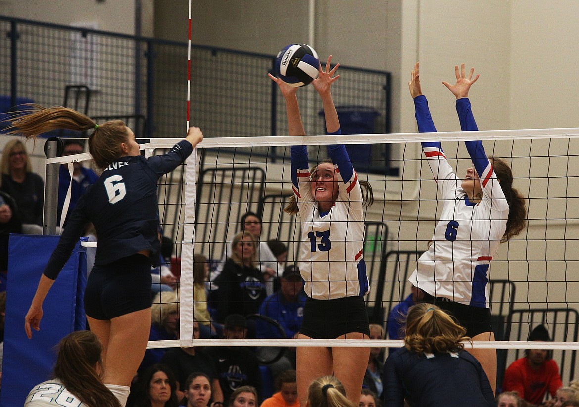 Coeur d&#146;Alene High&#146;s Emma Fahy (13) and Lili Hare (6) block Lake City&#146;s Kate DuCoeur&#146;s spike in the 5A Region 1 championship match last Tuesday at Coeur d&#146;Alene.