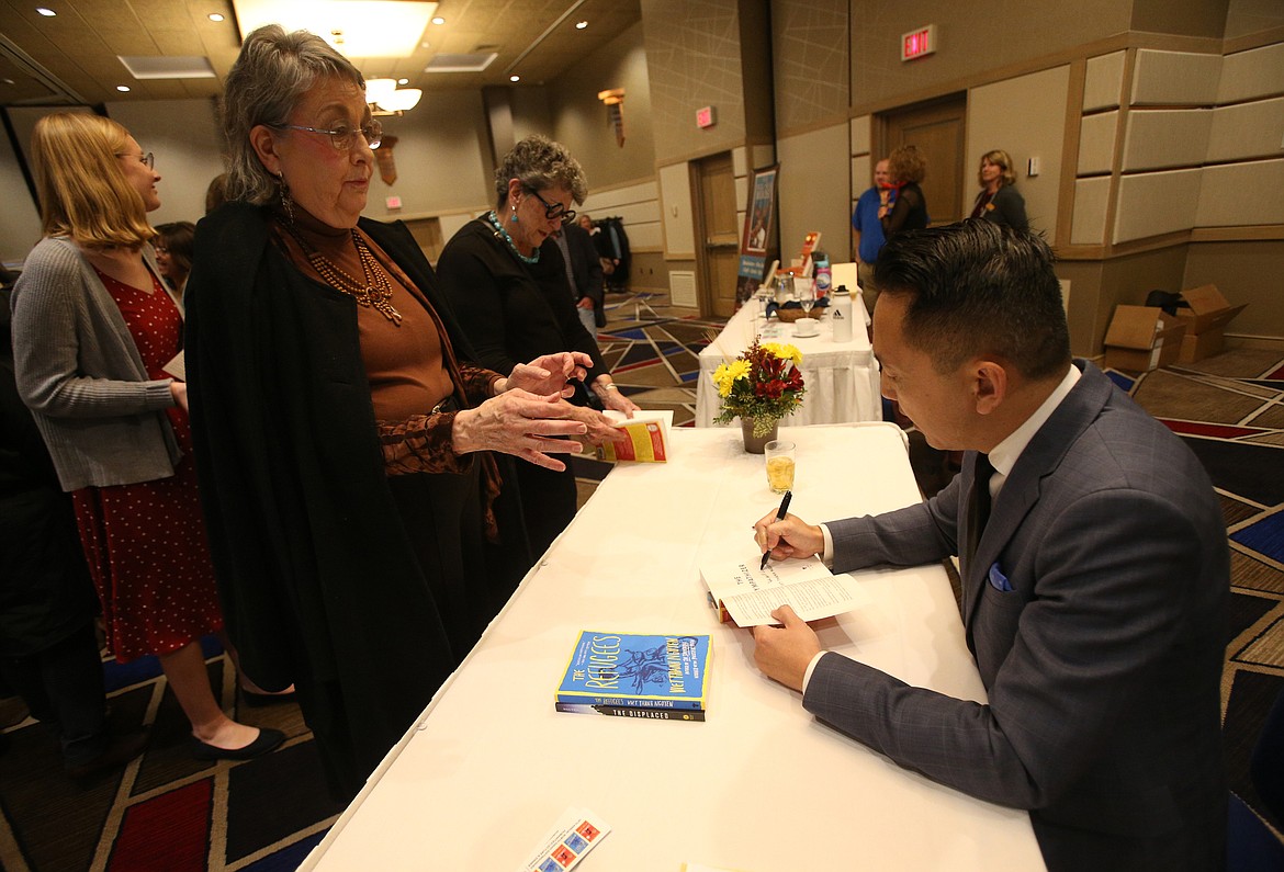 Writer Viet Thanh Nguyen signs a book for Kristy Johnson of Post Falls during the Idaho Humanities Council&#146;s 16th annual North Idaho Distinguished Humanities Lecture at The Coeur d&#146;Alene Resort.