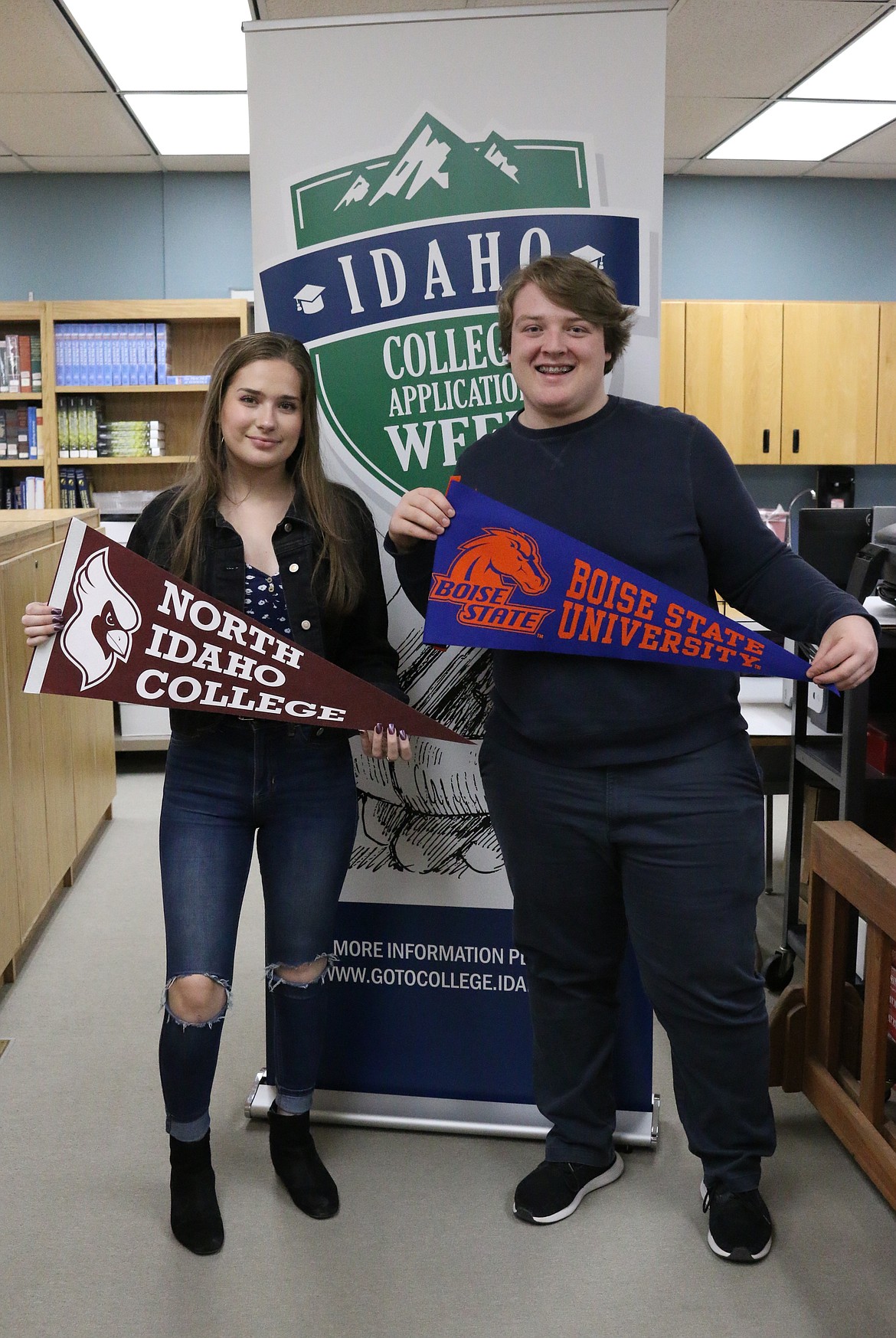 Sandpoint High School seniors Cicorra Stiles and Lukas Aanes pose with pendants from Idaho schools they spent their designated class period on Monday applying to as part of the statewide College Application Week initiative.

(Photo by
MARY MALONE)