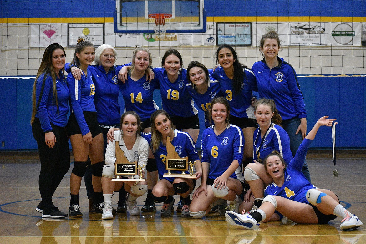 (Photo by DYLAN GREENE) The Lady Cats pose for a photo after winning the district tournament Saturday.