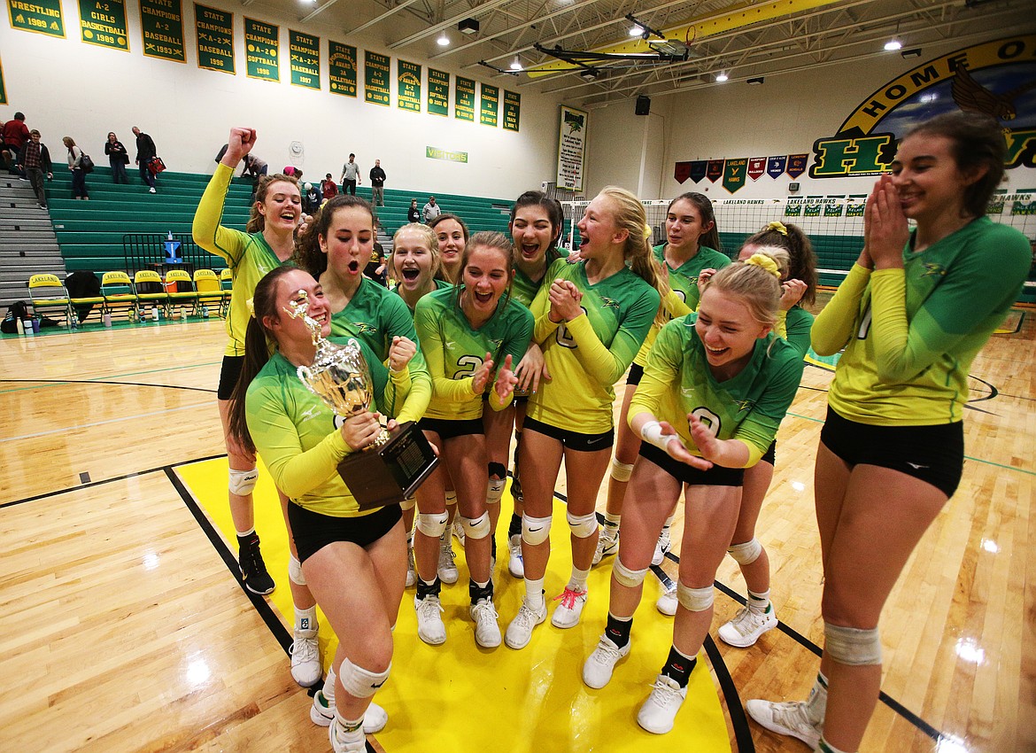 The Lakeland Hawks volleyball team celebrates its 4A Region 1 championship win over Moscow on Thursday night in Rathdrum. 

LOREN BENOIT/Press