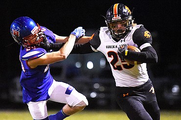 Eureka tight end Cory Chaney (25) extends a stiff-arm to Bigfork linebacker Kainin Lafontaine (24) on a reception in the first quarter at Bigfork High School on Friday. (Casey Kreider/Daily Inter Lake)