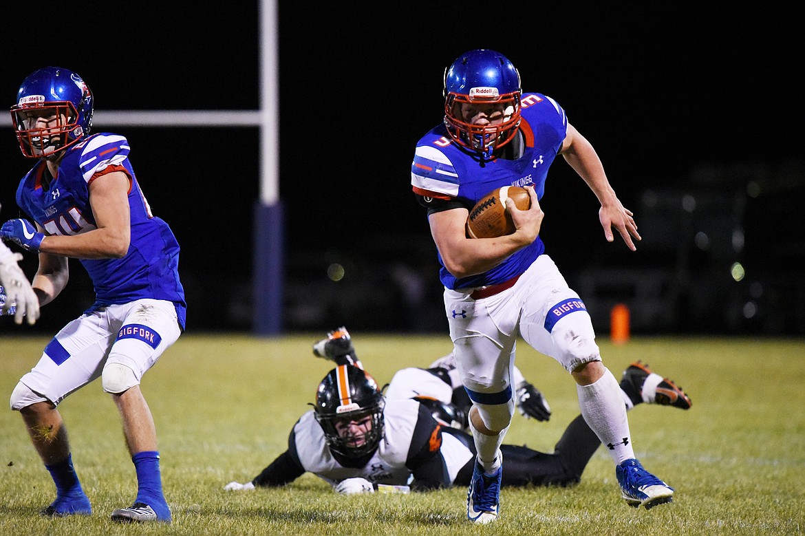 Bigfork running back Levi Taylor (3) gets around the edge on a run in the second quarter against Eureka at Bigfork High School on Friday. (Casey Kreider/Daily Inter Lake)