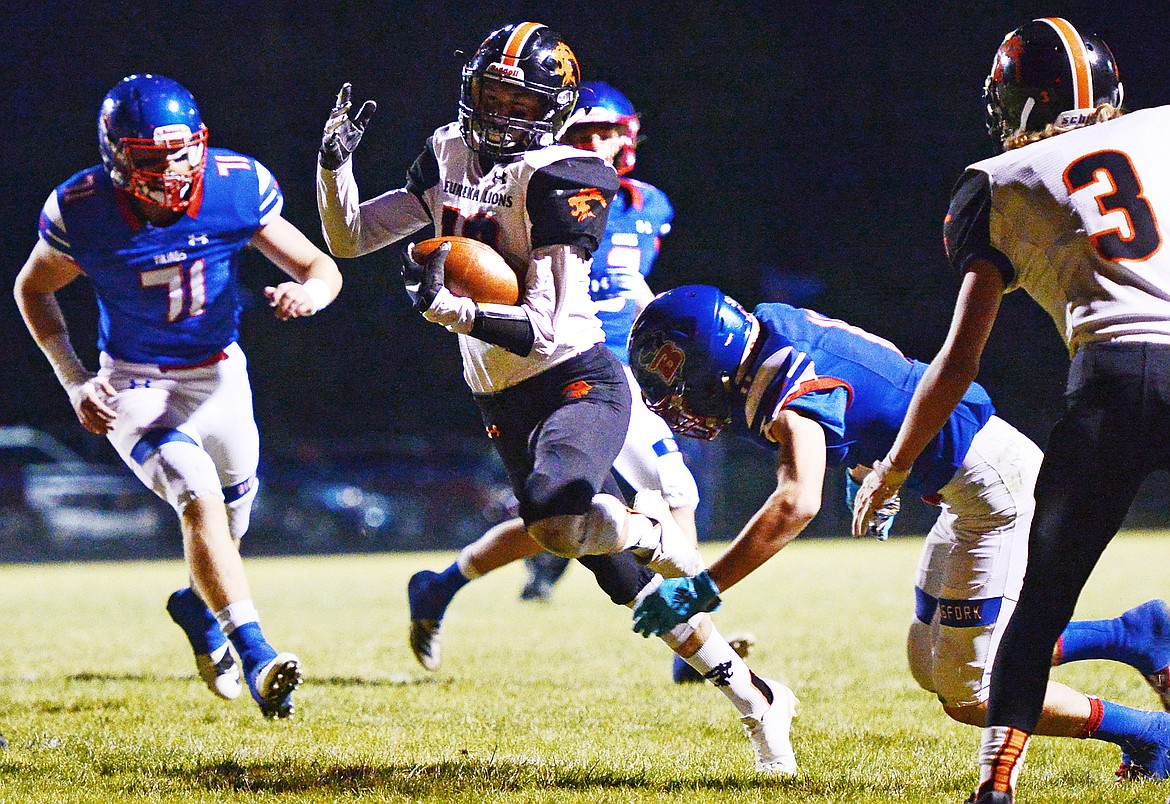 Eureka wide receiver Austin Sartori (10) breaks a tackle en route to a first quarter touchdown against Bigfork at Bigfork High School on Friday. (Casey Kreider/Daily Inter Lake)