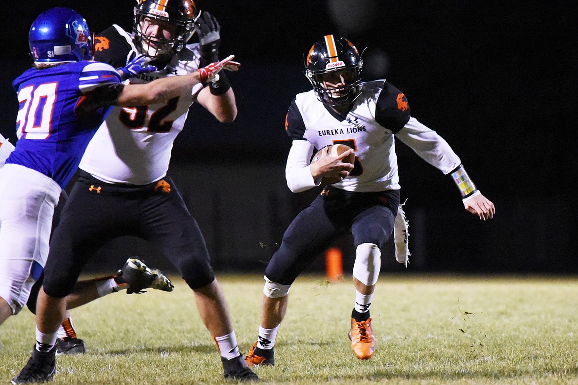 Eureka quarterback Hank Dunn (5) takes off running in the second quarter against Bigfork at Bigfork High School on Friday. (Casey Kreider/Daily Inter Lake)