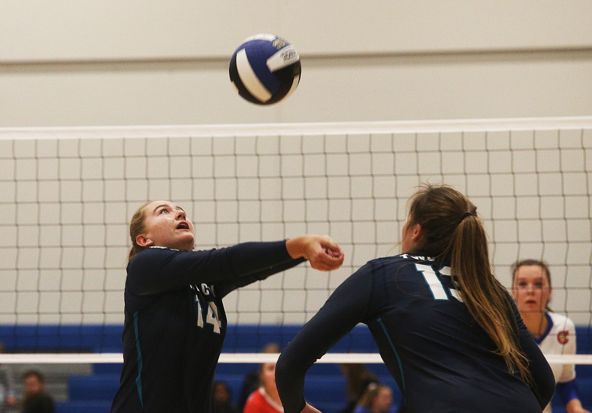 Lake City&#146;s Ella Hosfelt bump-sets as teammate Hannah Rowan watches in the 5A Region 1 championship match against Coeur d&#146;Alene on Tuesday night at Viking Court. (LOREN BENOIT/Press)