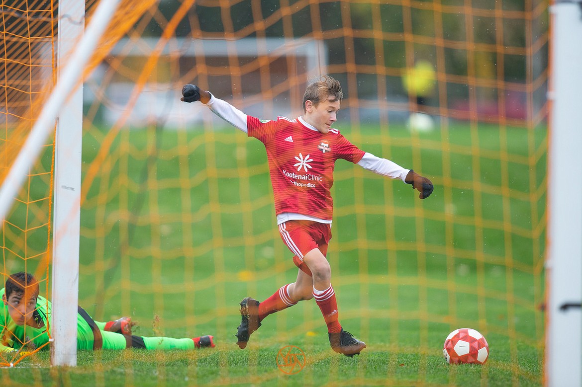 Photo by BUSCEMA PHOTOGRAPHY
The Timbers North FC 06 Boys White soccer team headed to Pasco, Wash., to battle 3 Rivers 3RSC B06 White in the rain and wind. The game ended with a 3-3 tie after the Timbers trailed for most of the game. Devin Pearson scored a goal and Spencer Nelson made two goals for the Timbers, and Ari Rumpler made an assist. Pictured is Spencer Nelson scoring one of his two goals.