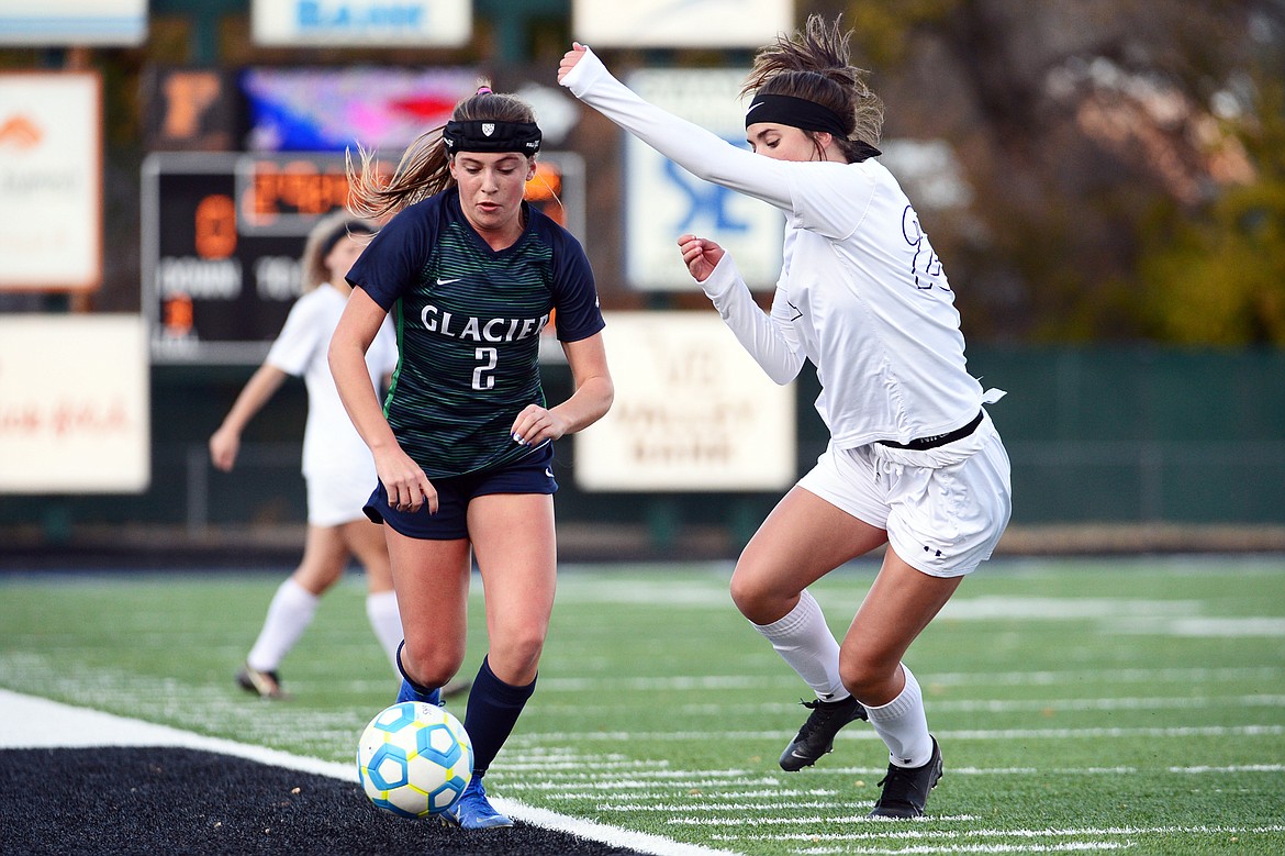 Glacier's Emily Cleveland (2) moves the ball upfield against Butte's Christiana Beierle (21) in the first half at Legends Stadium on Tuesday. (Casey Kreider/Daily Inter Lake)