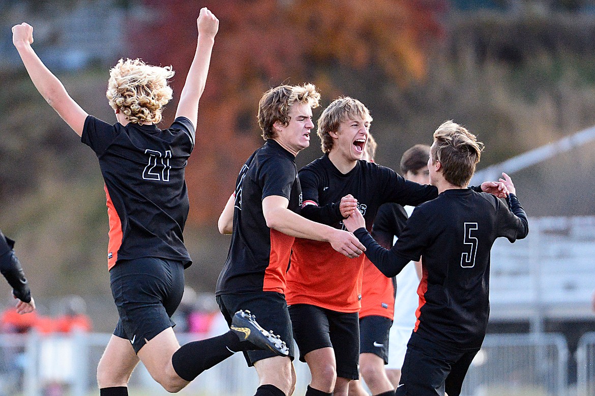 From left, Flathead's Ethan Vandenbosch (21), Camas Rinehart (16), Jalen Hawes (7) and AJ Apple (5) celebrate after Apple's goal in the first half against Glacier at Legends Stadium on Tuesday. (Casey Kreider/Daily Inter Lake)