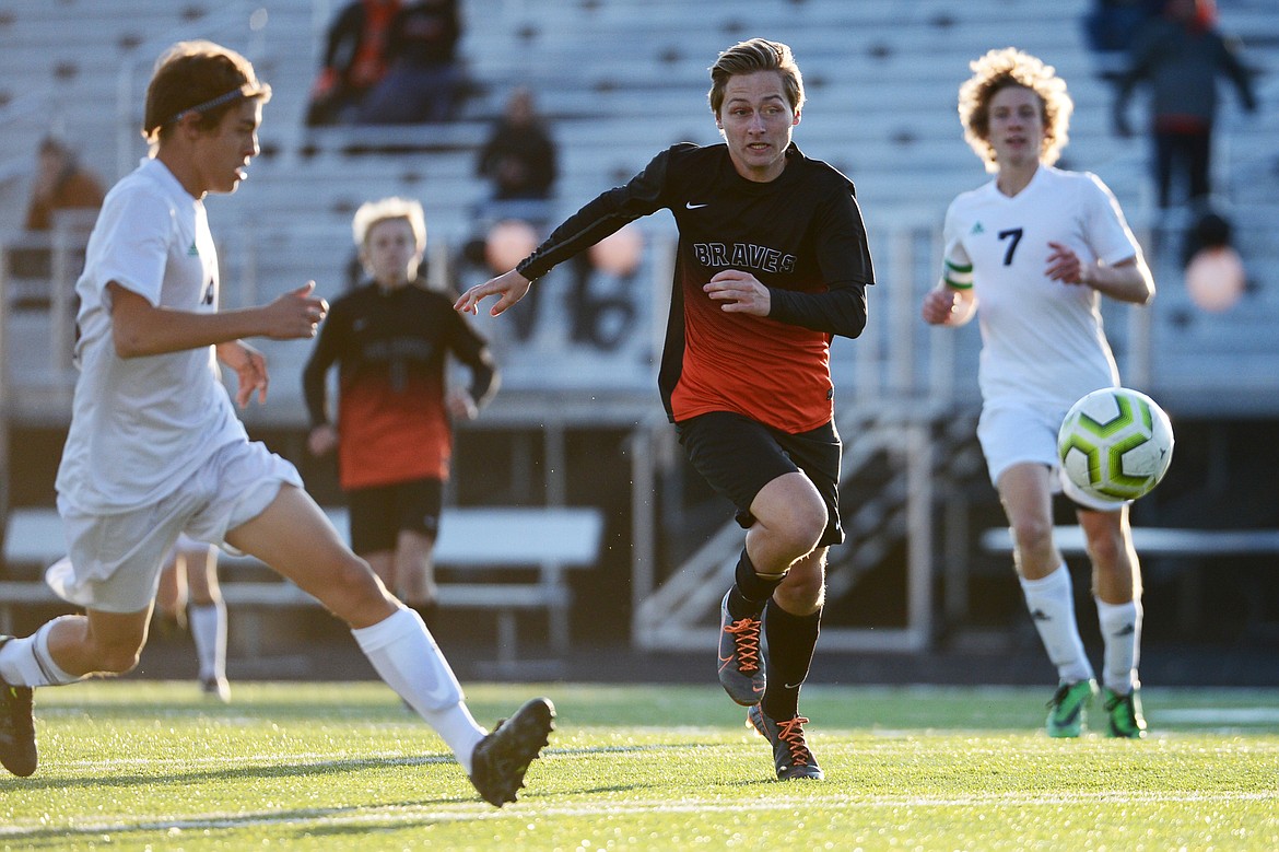 Flathead's AJ Apple (5) races Glacier's Sebastiano Pipolo (16) for a loose ball in the first half at Legends Stadium on Tuesday. (Casey Kreider/Daily Inter Lake)