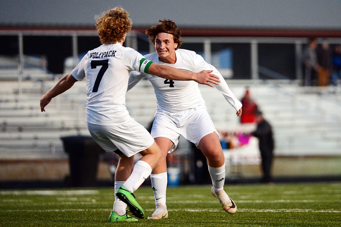 Glacier's Micah Heil (7) and Braden Nitschelm (4) celebrate after Heil's goal in the second half against Flathead at Legends Stadium on Tuesday. (Casey Kreider/Daily Inter Lake)