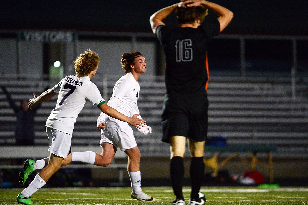 Glacier's Micah Heil (7) and Braden Nitschelm (4) celebrate after Nitschelm's game-winning goal in stoppage time against Flathead at Legends Stadium on Tuesday. (Casey Kreider/Daily Inter Lake)