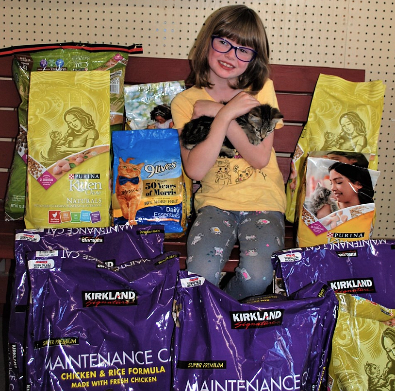 Courtesy photo
Coeur d&#146;Alene 7-year-old Colette Collins snuggles a kitty at the Kootenai Humane Society after she and her parents deliver well more than 100 pounds of cat and kitten food that Colette requested to donate to the shelter for her birthday. &#147;I love the kitties,&#148; Colette said. &#147;They&#146;re so cute and they need homes.&#148;