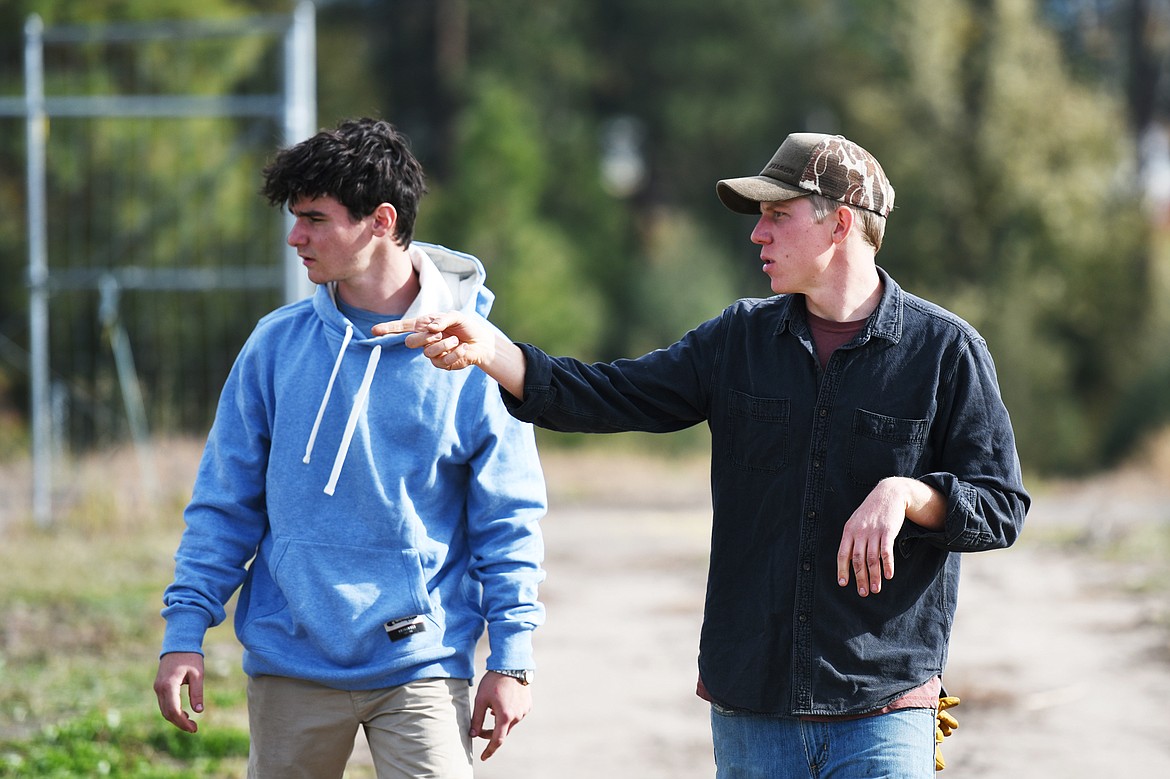 Gray Isom, left, a student in the soil nutrients management program, and Dane Regan, FVCC farm manager, walk along the FVCC farm property on Tuesday, Oct. 15. Casey Kreider/Daily Inter Lake)