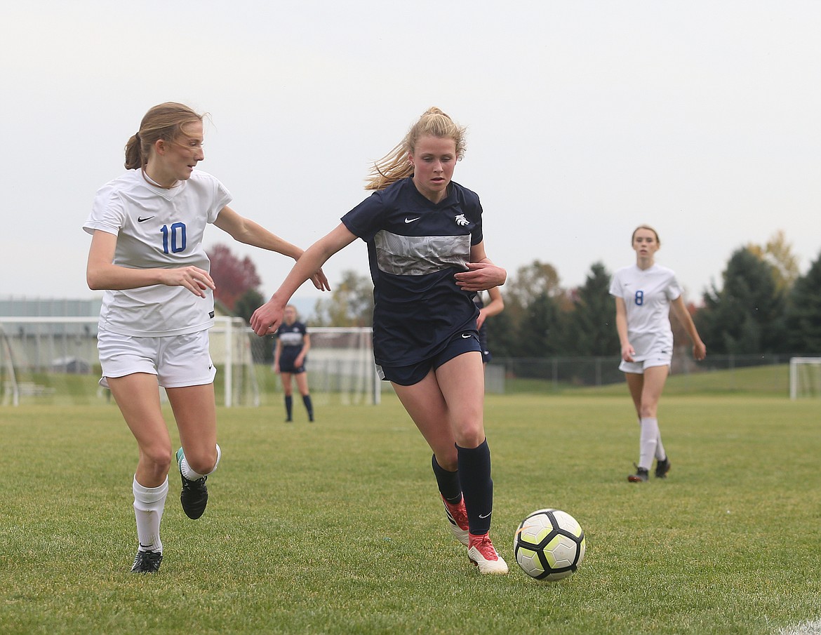 Lake City&#146;s Lily Fletcher dribbles the ball near the sideline while defended by Coeur d&#146;Alene&#146;s Zoe Cox in the 5A Region 1 championship game at Lake City.