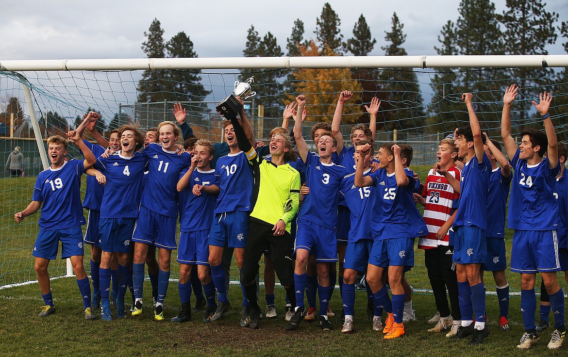 The Coeur d&#146;Alene High School boys soccer team celebrates its 5A Region 1 championship win over Lake City.