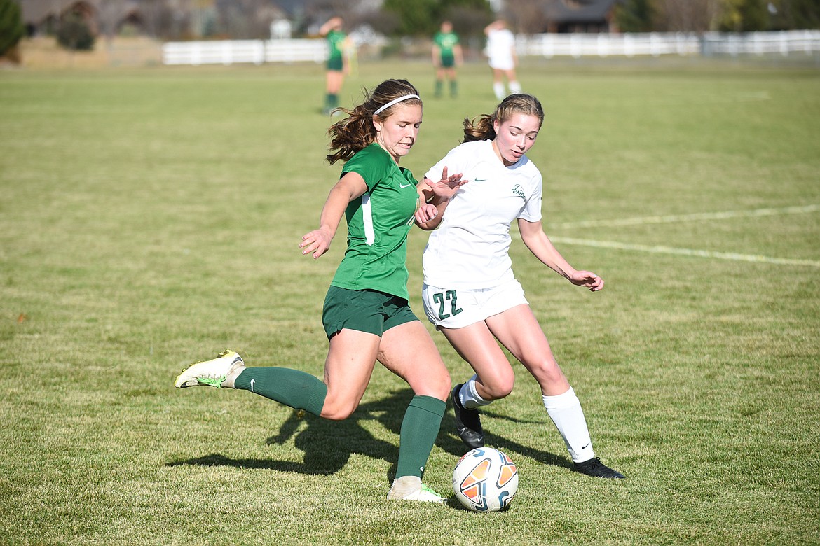 Emma Barron fights for possession during the Lady Dogs' home semifinal loss on Saturday. (Daniel McKay/Whitefish Pilot)