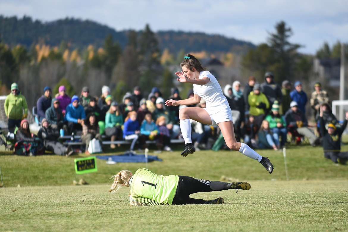 Bulldog keeper Sami Galbraith slides under a Billings Central player during the Lady Dogs&#146; home semifinal loss on Saturday at home. (Daniel McKay/Whitefish Pilot)