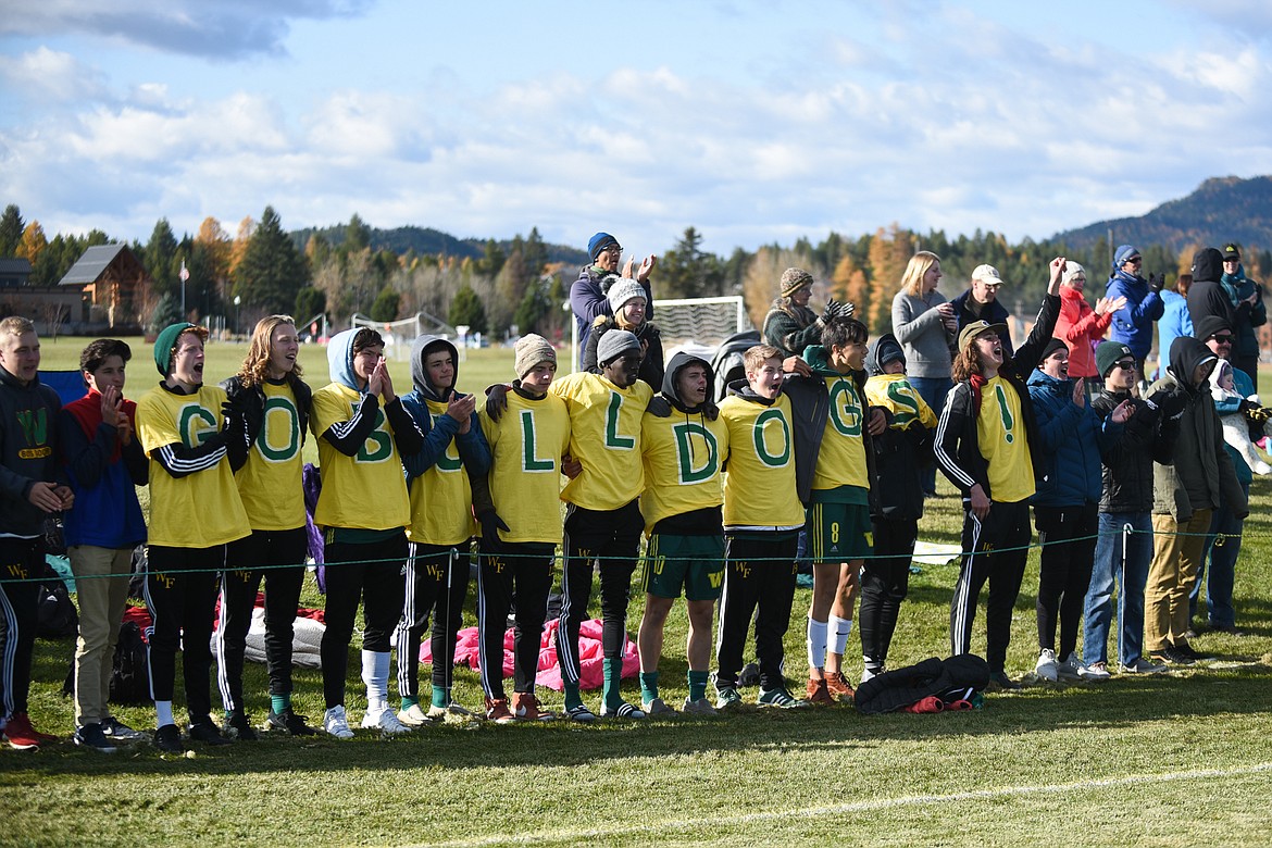 The Bulldogs boys soccer team cheers on the girls after their semifinal loss on Saturday. (Daniel McKay/Whitefish Pilot)