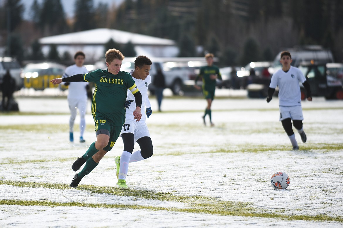 Casey Schneider fights past a Billings defender during the Bulldogs' semifinal win at home on Saturday. (Daniel McKay/Whitefish Pilot)