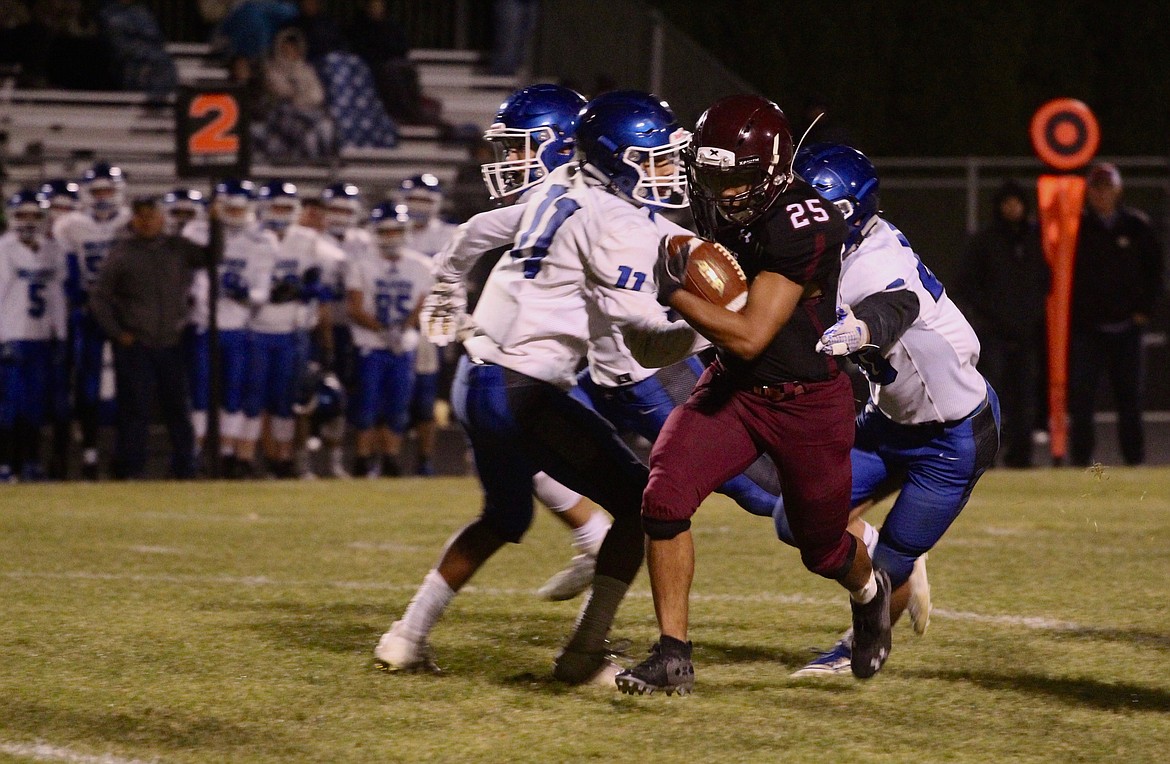 Casey McCarthy/Columbia Basin Herald Jose Celaya carries the ball for the Warriors on Friday night against Warden on Senior Night.