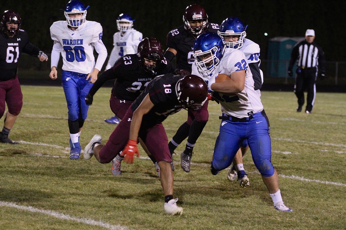 Casey McCarthy/Columbia Basin Herald Warden&#146;s Julian Egia fights his forward as Wahluke&#146;s Isaac Sanchez attempts to bring him to the ground.