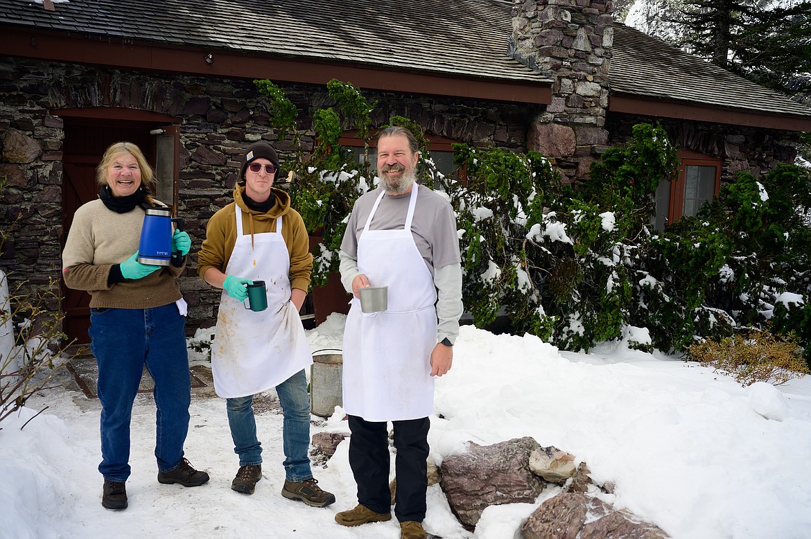 From left, kitchen crew members Ellen Hargrave and Logan and Mike Warrington. Behind them is one of the trees that narrowly missed falling on the dining hall during a storm.