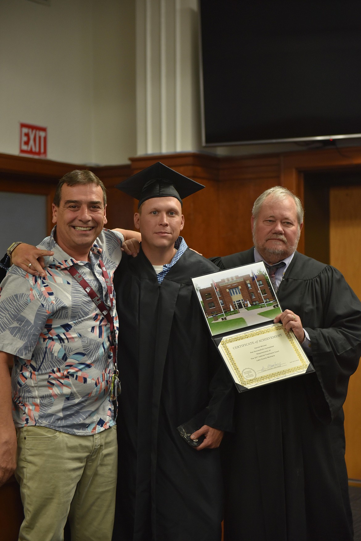 Reclaiming his life, Harold Mitchell (center) receives his hard-earned diploma for successfully completing Lake County Drug Court&#146;s addiction treatment program from Judge James A. Manley, with support from the program&#146;s director, Jay Brewer. (Carolyn Hidy/Lake County Leader)