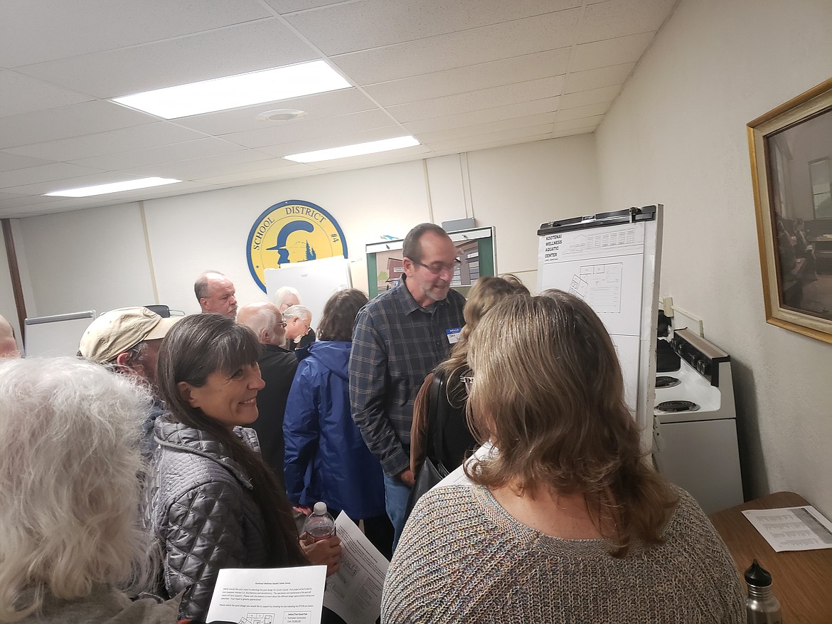 Community members circle around to hear from KWAC members about potential pool designs for Libby. (Tana Wilson/The Western News)