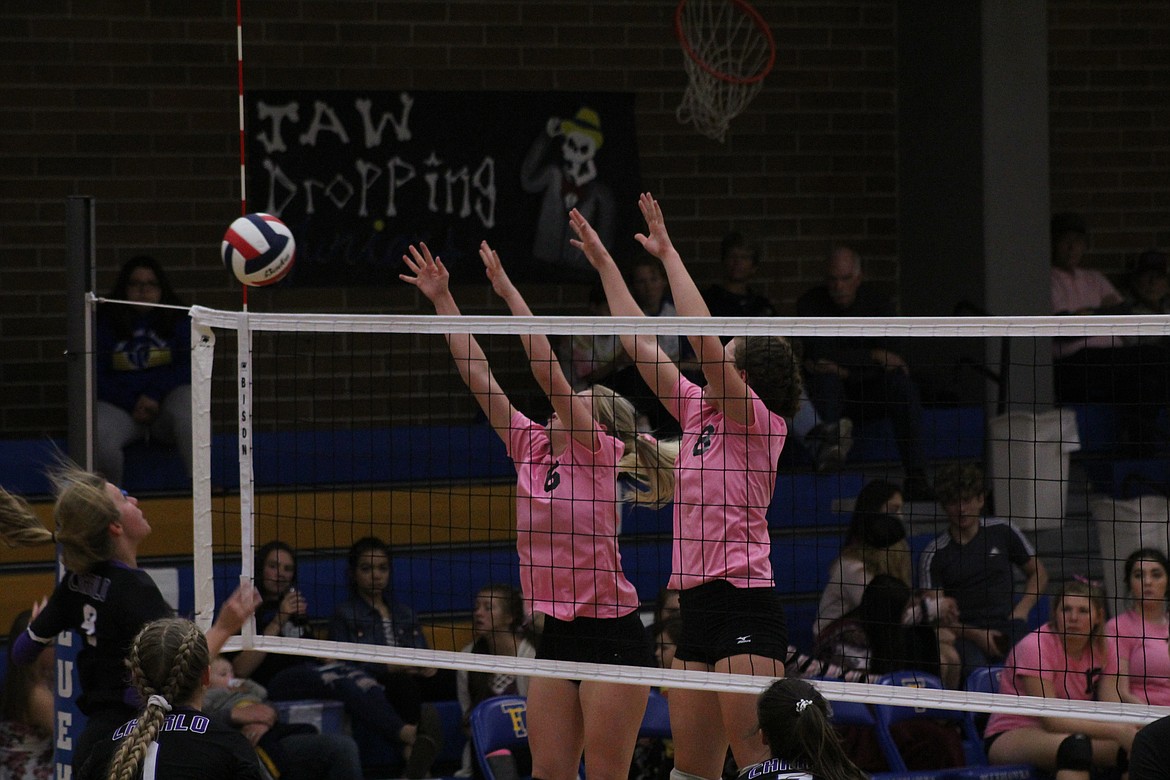 RILEY WILSON and Jody Detlaff leaping to stop a spike from Charlo last Thursday night. (John Dowd/Clark Fork Valley Press)
