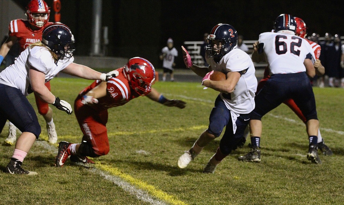 Casey McCarthy/Columbia Basin Herald Ellensburg's Brenden Swanson rushes to the outside against Othello on Friday night.