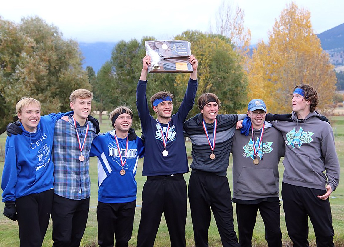 The Wildcat cross country team of TJ Jacobi, Aidan Jarvis, Seth Umbriaco, James Petersen, James Role, Joe Lamb and Bailey Sjostrom celebrate with the Western A Division trophy in Hamilton Saturday. (Katrina Lamb photo)