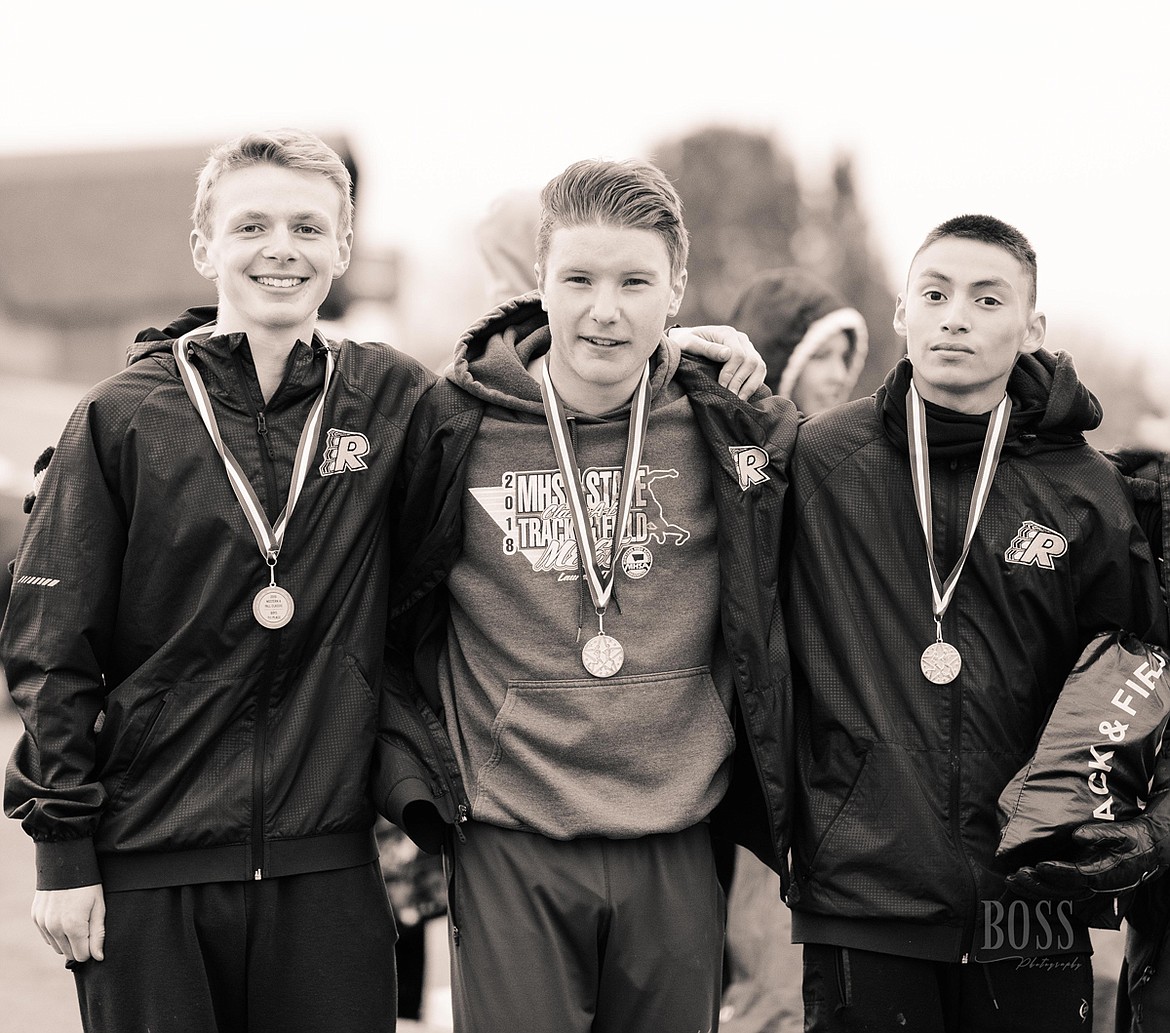 Ronan boys Western A Classic top 15 all-conference runners Brant Heiner (7th), James Normnandeau (2nd) and Michael Irvine (8th) pause for a team photo op at the Hamilton Golf Course. (Photo courtesy of Kristi Sopke)