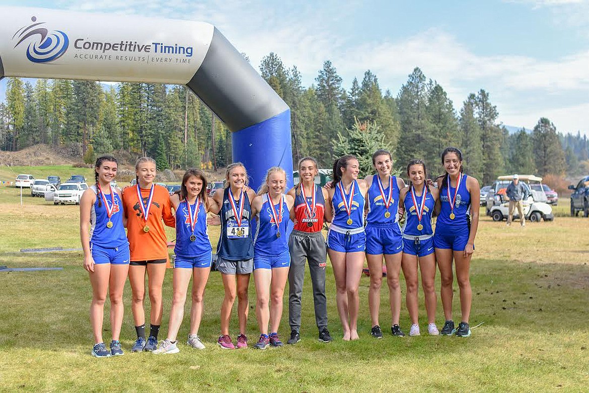 The 2019 Western B Divisional cross-country top ten girls all-conference finishers strike a pose after their race at Rivers Bend Golf Course in Thompson Falls. Left to right, in ascending order: (10th) Scout Jessop (Bigfork), (9th) Maya Carvey (Eureka), (8th) Tabitha Raymond (Bigfork), (7th) Cora Pesanti (Anaconda), (6th), Grace Stewart (Bigfork), (5th) Carolyn Kimball (Loyola), (4th) Ellie Baxter (T-Falls), (3rd) Sierra Hanks (T-Falls), (2nd) Josey Neesvig (T-Falls), (1st) Karolyna Buck (Mission).  (Photo courtesy of Christa Umphrey, Forward Photography)