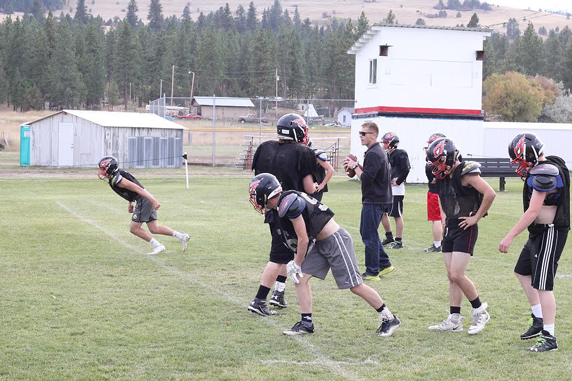 Hot Springs assistant coach Andrew Leichtnam works with Savage Heat players during a recent practice. Hot Springs is 8-0 and hoping to win a third state title since 2012. (Chuck Bandel/Valley Press)