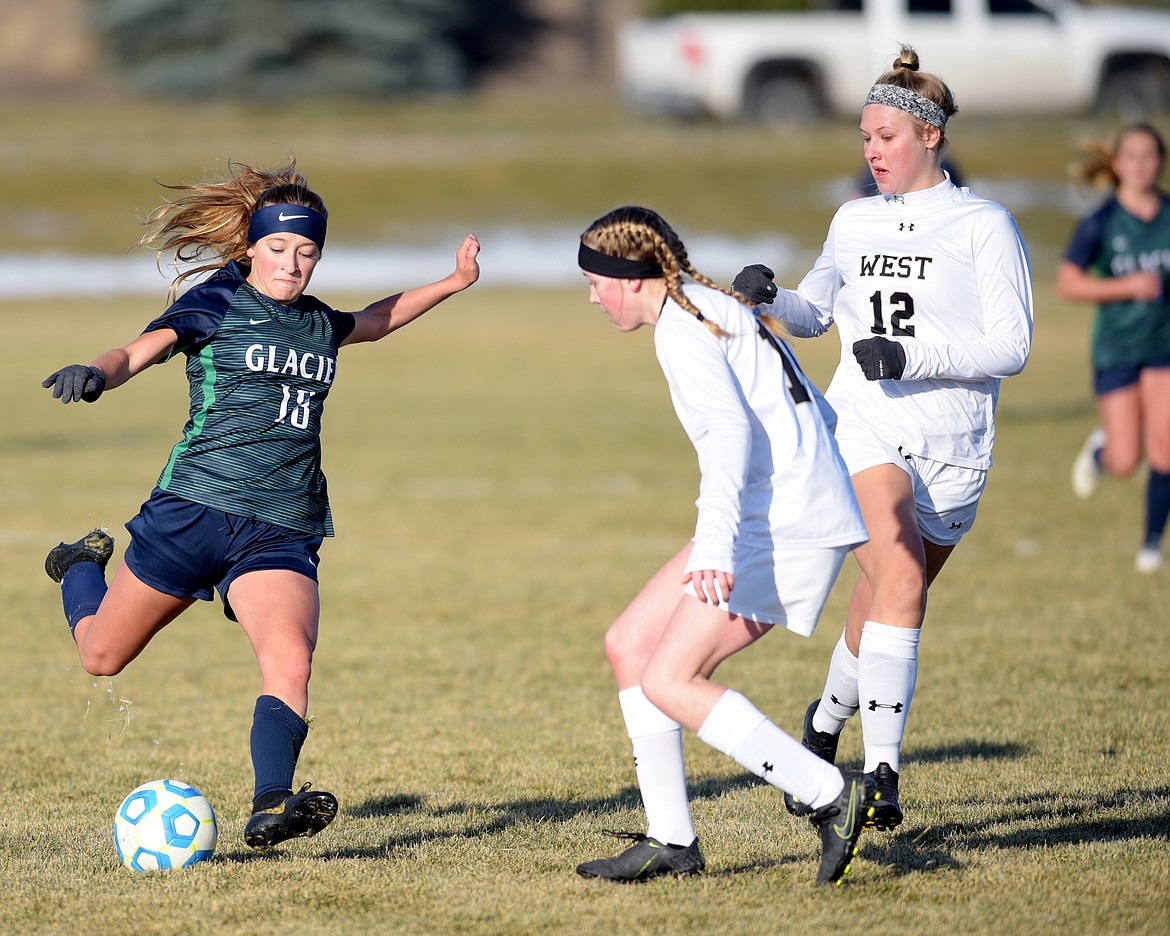 From left, Glacier junior Madison Becker, 18, passes the ball past Billings West freshman Maeghan Forsyth and junior Greta Morgan during the first half of their game on Wednesday, October 30. At halftime the score was Billings West 2, Glacier 0.(Brenda Ahearn/Daily Inter Lake)