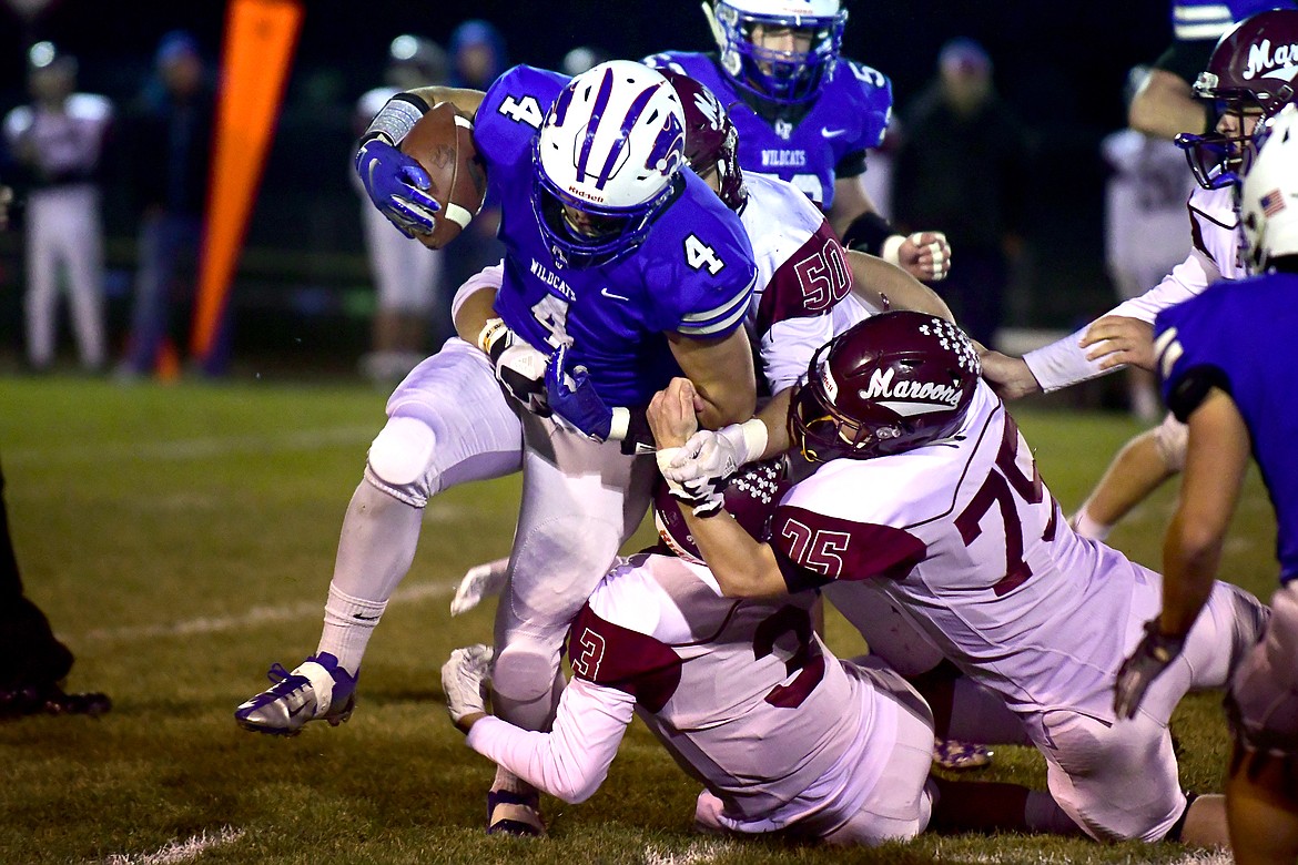 Bradley Nieves fights past a number of Maroon defenders in the first quarter Friday. (Jeremy Weber photo)