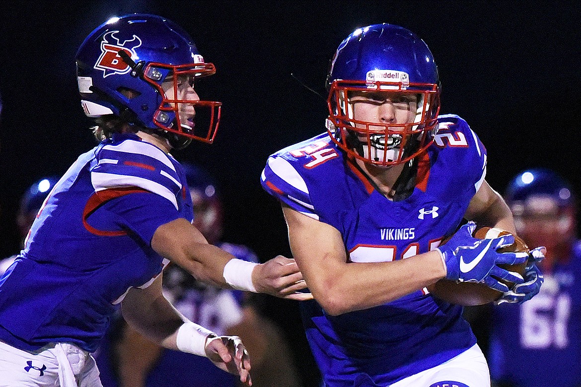 Bigfork quarterback Patrick Wallen (10) hands off to running back Kainin Lafontaine (24) in the first quarter against Eureka at Bigfork High School on Friday. (Casey Kreider/Daily Inter Lake)