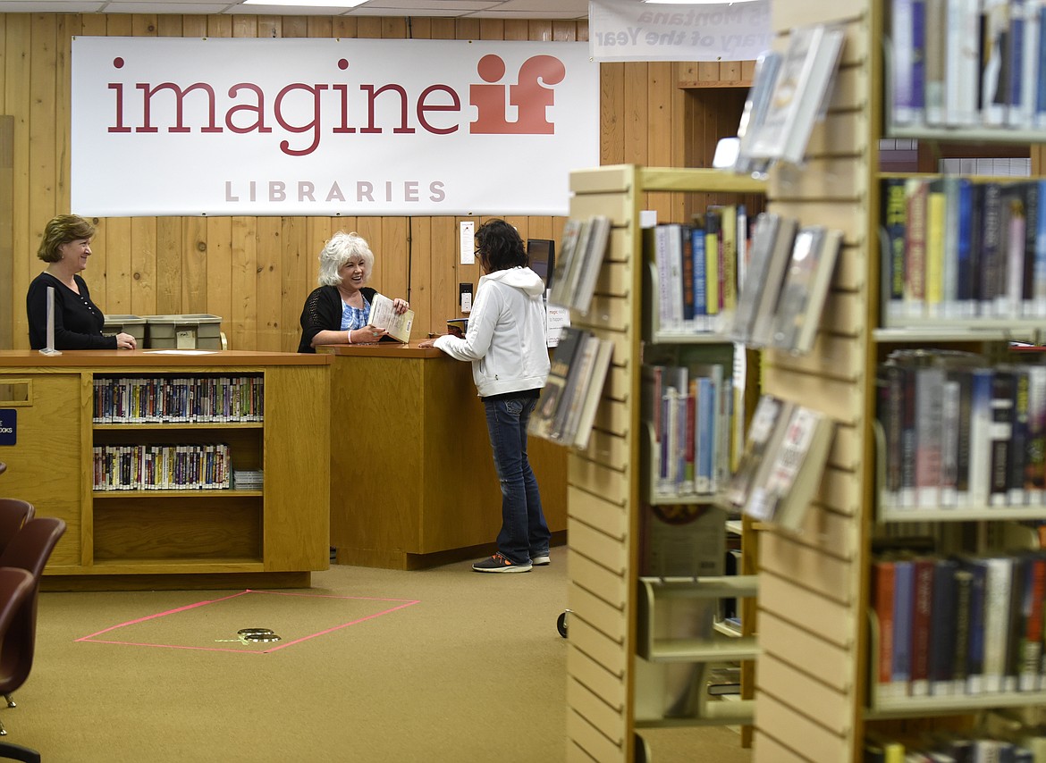 ImagineIf Bigfork Library advisor Carolyn Naso, left, and branch manager Annie Leberman talk to a patron at the library on Thursday. The library will be closed May 13 to May 16 for remodeling. (Aaric Bryan/Daily Inter Lake)