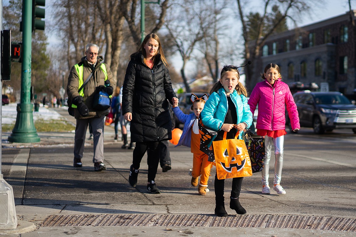 A group of trick or treaters head to Central Avenue during the Whitefish Trick or Treat downtown on Thursday. (Daniel McKay/Whitefish Pilot)