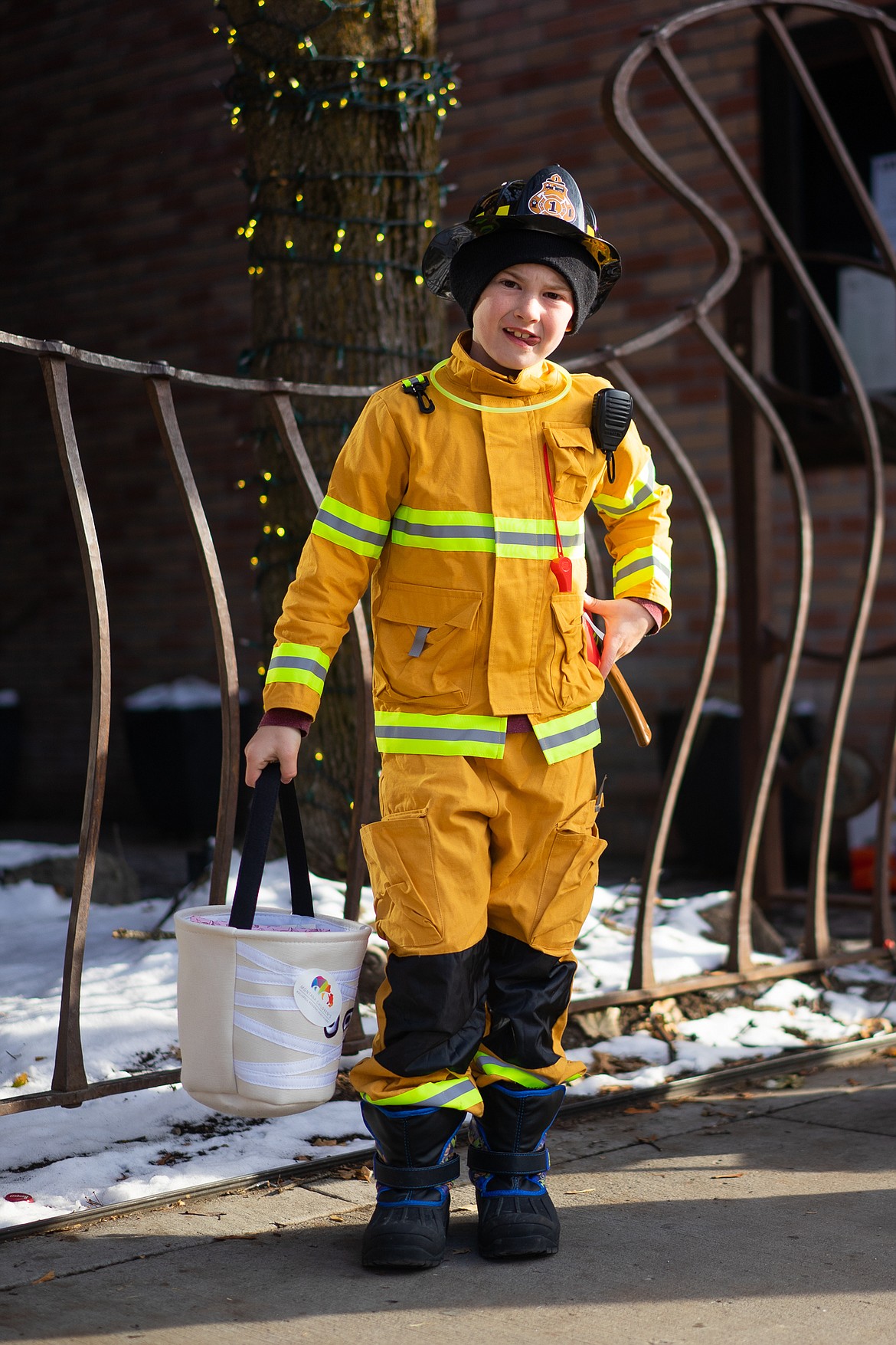A Whitefish fireman smiles for the camera during the Whitefish Trick or Treat downtown on Thursday. (Daniel McKay/Whitefish Pilot)