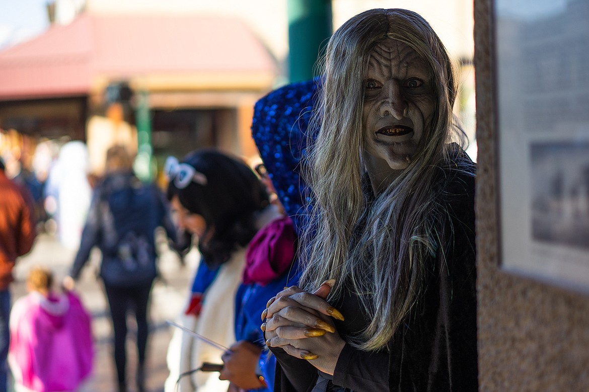 A creepy witch hands out candy on Central Avenue during the Whitefish Trick or Treat downtown on Thursday. (Daniel McKay/Whitefish Pilot)