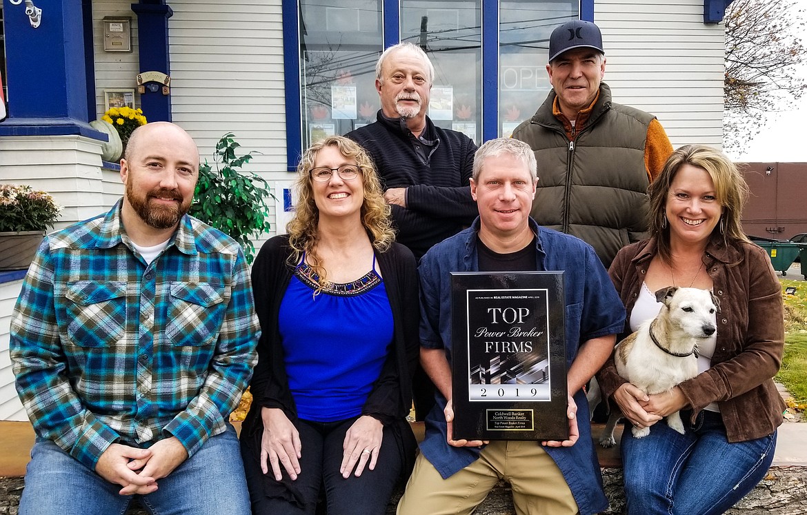 The Coldwell Banker North Woods Realty team. From left: Steve Holly, Lori Allen, Chris Clark in back, CJ Tuma, Tim Cady in back, office manager Kelly Wyatt, and mascot/&#147;door greeter&#148; Lola.