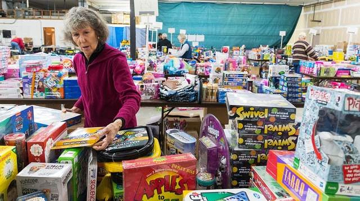 Press file
Volunteer Julia Mangan sorts games at the Toys for Tots staging area at Kootenai County Fire and Rescue training center in Post Falls on Nov. 20, 2015.