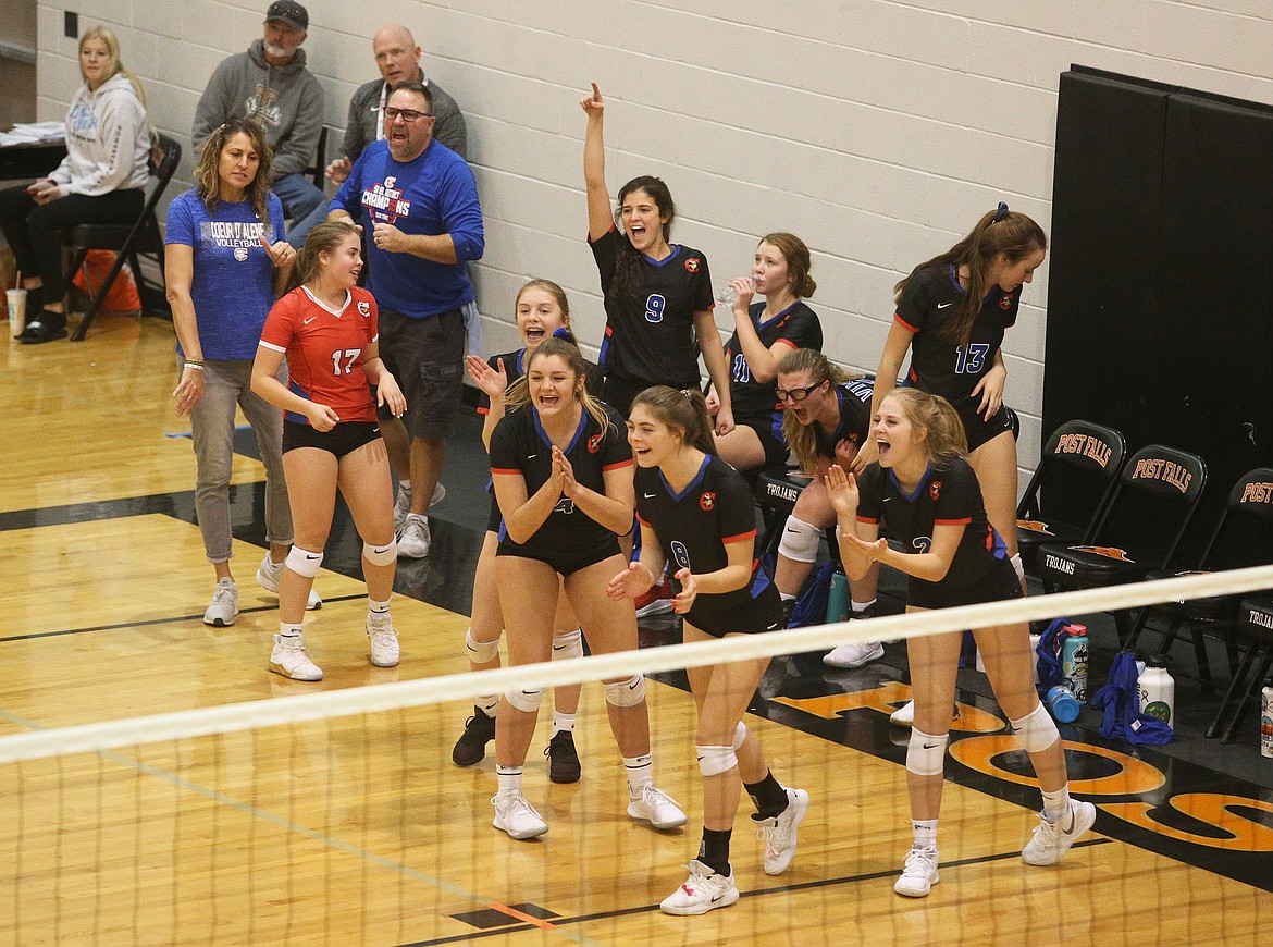 The Coeur d&#146;Alene High School volleyball bench celebrates a point in a match against Timberline High last Friday at the Idaho state 5A tournament at Post Falls High School.