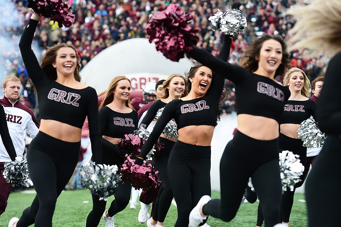 Members of the University of Montana Spirit Squad take the field before a game against Idaho at Washington-Grizzly Stadium on Saturday. (Casey Kreider/Daily Inter Lake)