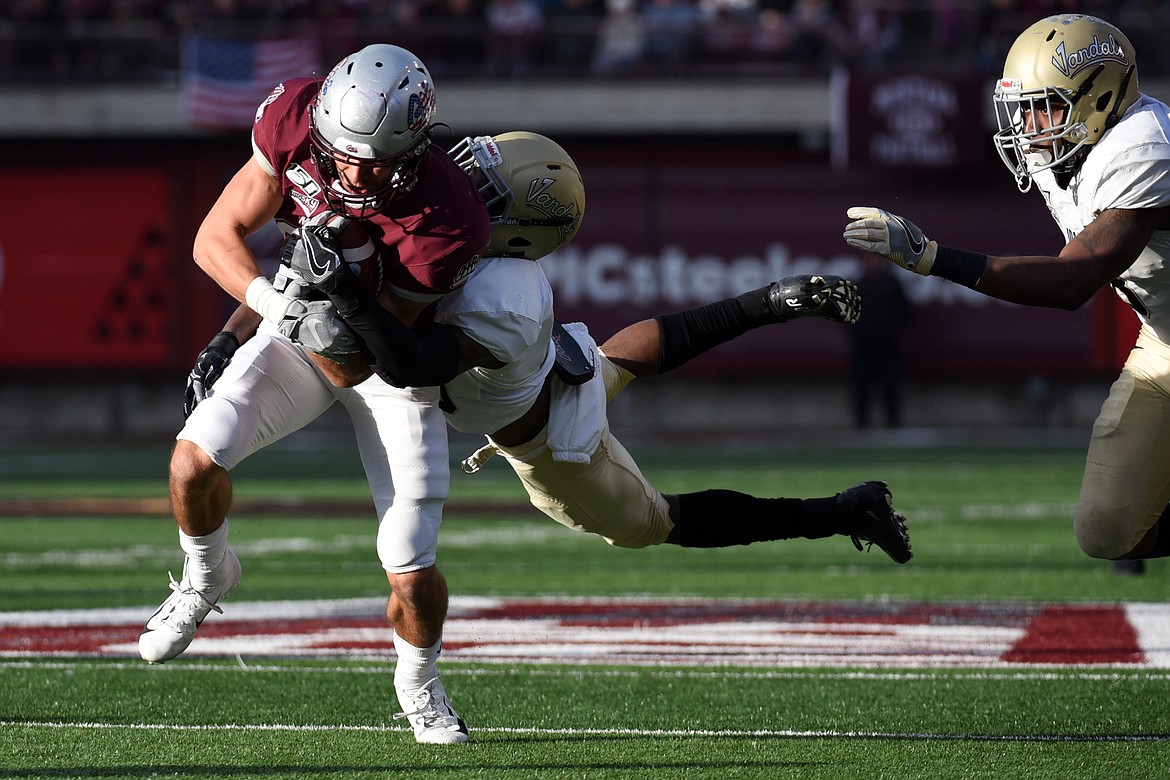 Montana wide receiver Mitch Roberts (80) is brought down by Idaho defensive back Jalen Hoover (25) on a 9-yard reception in the third quarter at Washington-Grizzly Stadium on Saturday. (Casey Kreider/Daily Inter Lake)